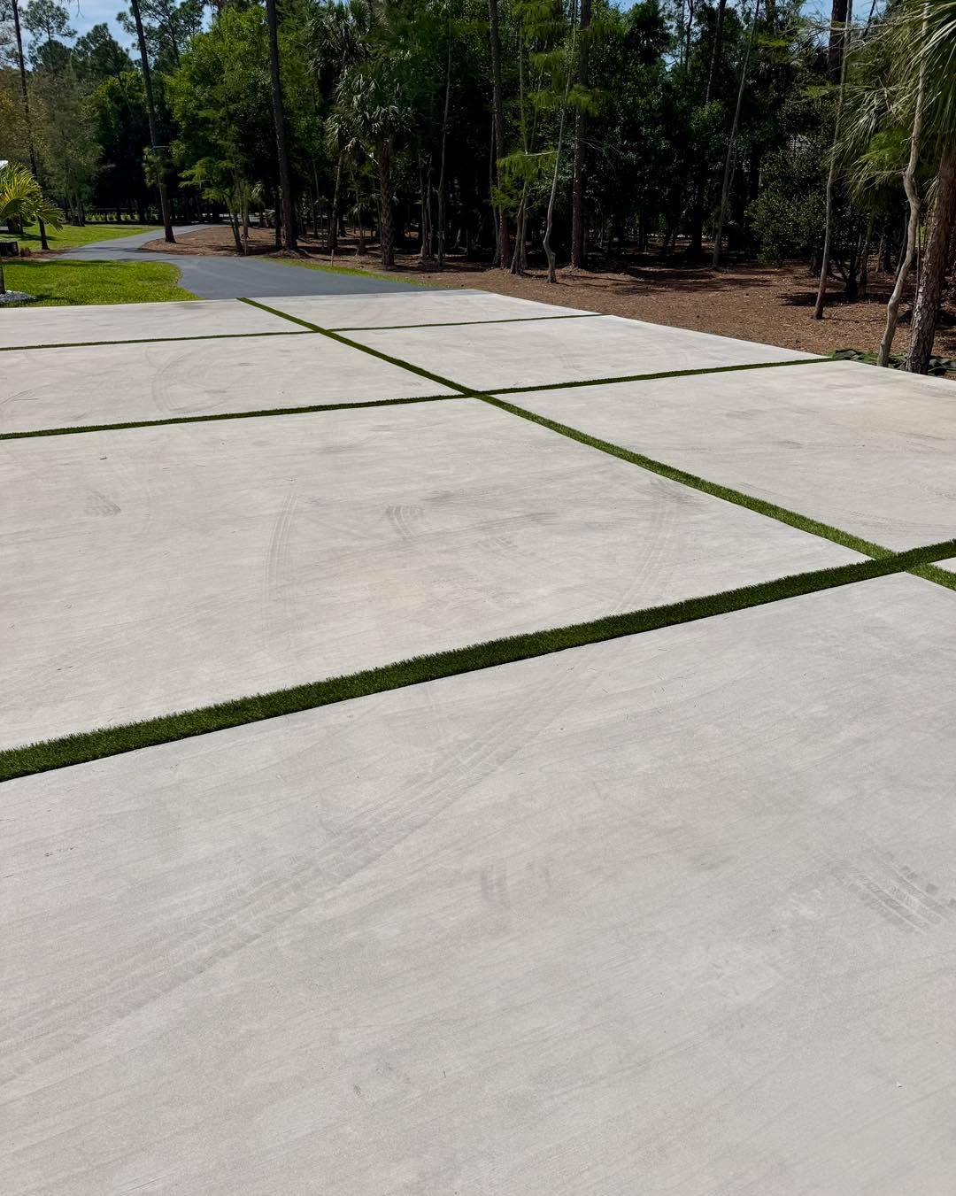 Concrete driveway with turf inlays