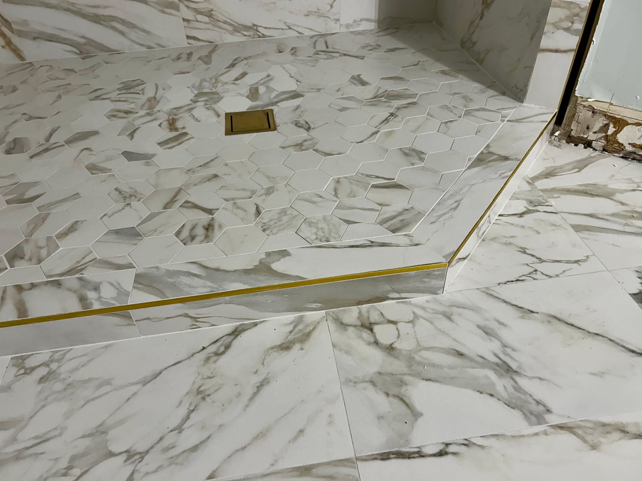 Marble floor installation with brass inlay