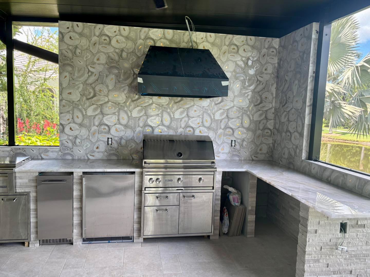 Custom outdoor kitchen with stone accent wall